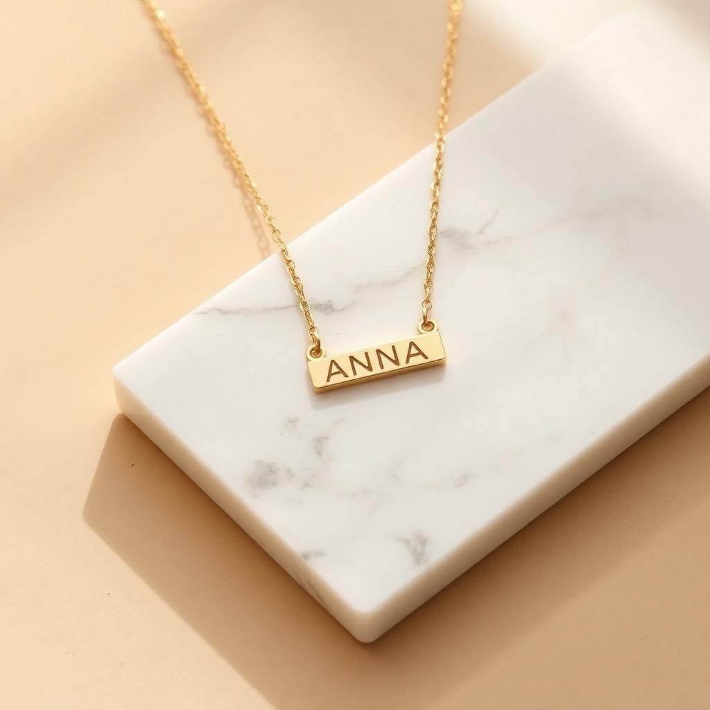 Vertical bar name necklace in yellow gold on warm marble
