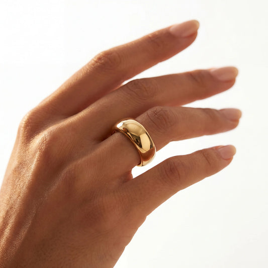 Yellow gold domed band ring worn on hand