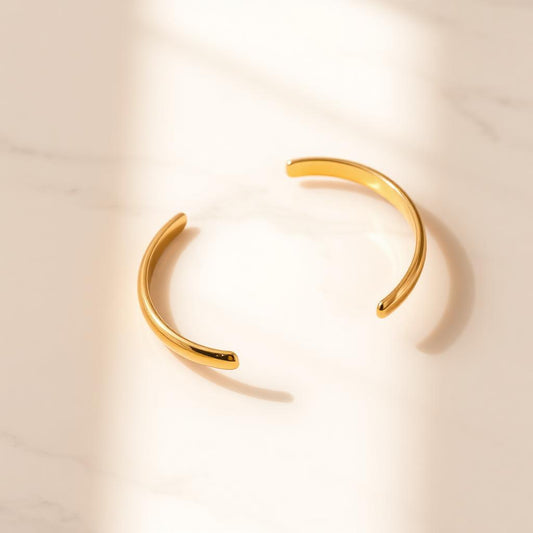 Yellow gold classic open cuff on warm marble