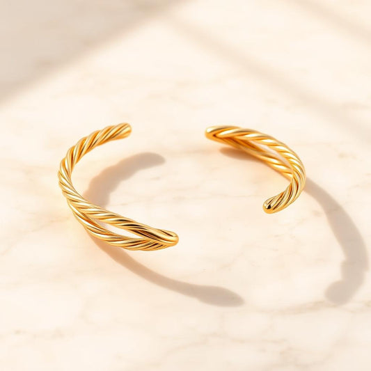 Yellow gold twist cuff on warm marble