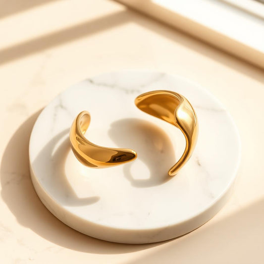 Yellow gold molten cuff on warm marble
