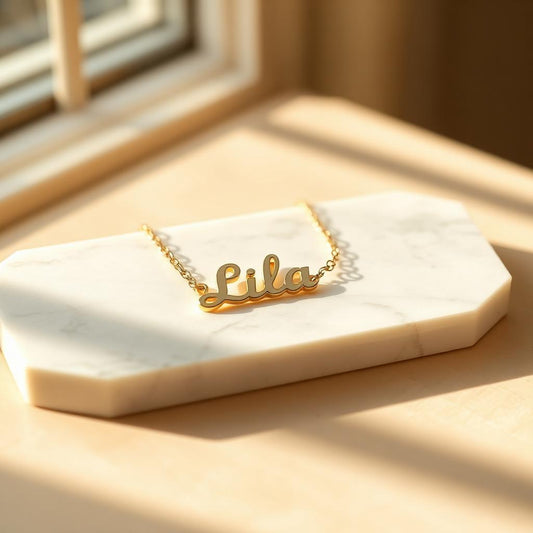 Mini name choker in yellow gold on warm marble