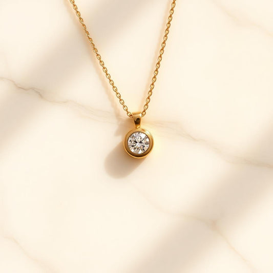 Yellow gold floating solitaire pendant on warm marble