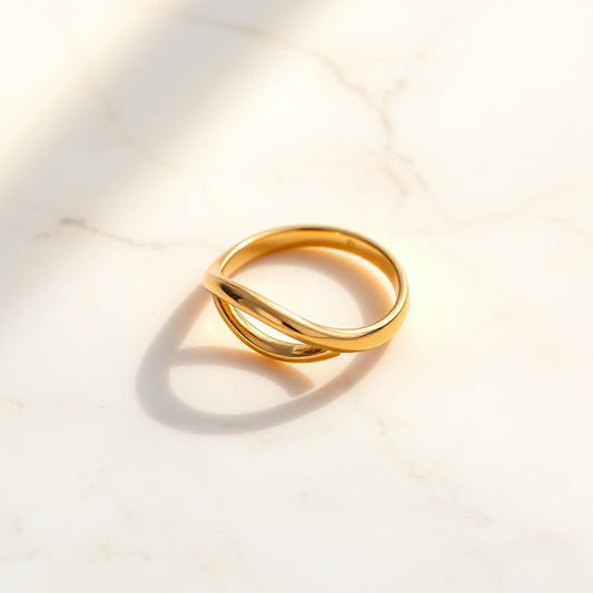 Yellow gold twist ring on warm marble